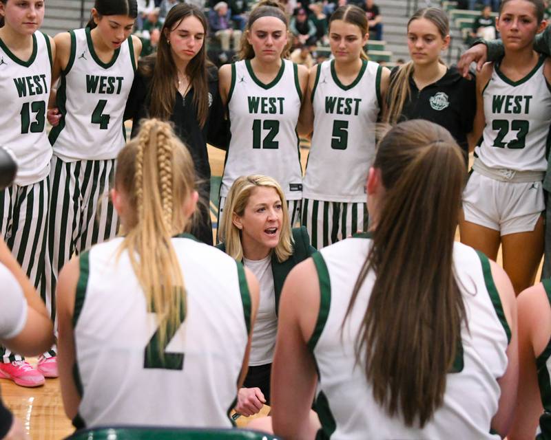 Glenbard West's head coach Kristi Faulkner talks to the team between quarters on Thursday Feb. 26, 2026, during the 4A Sectional championship game against St. Charles East held at Bartlett High School.