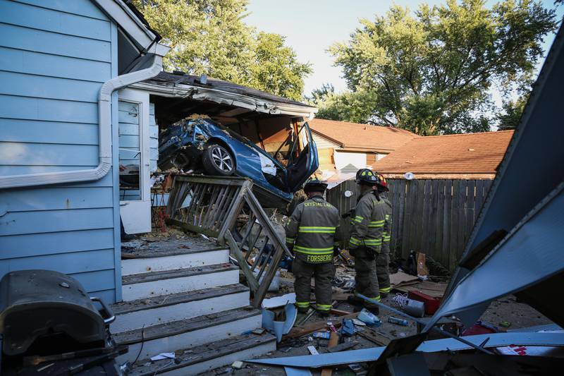 A vehicle crashed into a detached garage and home in Crystal Lake Wednesday, July 27, 2022, causing two people to sustain life-threatening injuries.