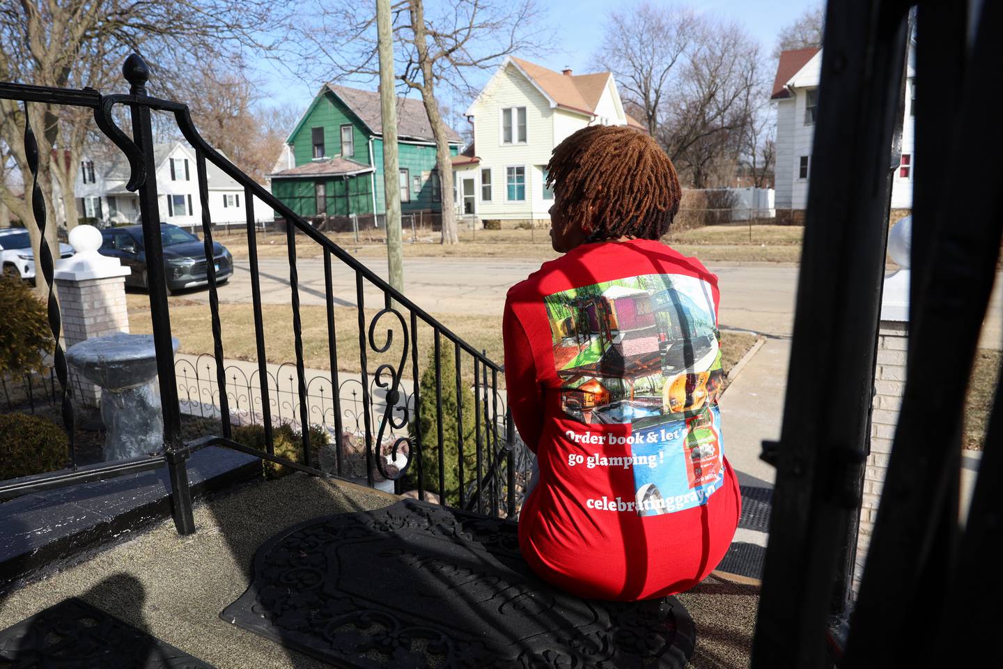 Carla Wills sits on the front porch of her former neighbor, Willa Smith, on North Greenwood Avenue in Kankakee where she often sat as a young girl hoping to catch a glimpse of her mother across the street. That difficult time in her life inspired her to write a book she recently wrote and self-published, titled “Celebrating Gray: Having the Audacity to in spite of.”