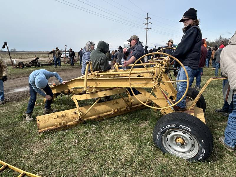 Elmer Heid, 11, and Gayn Gerke, 12, of Pearl City, check out an antique road grader at the Hazelhurst Spring Consignment Auction on Saturday, April 5, 2025.