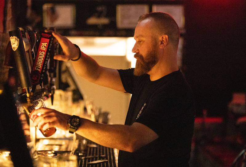 Bartender Steve Erd pours a drink at The House Pub in St. Charles on Friday, July 28, 2023. The House Pub has re-opened after roughly three years of being closed.