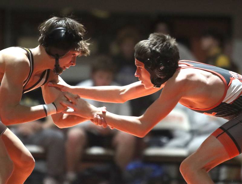 Crystal Lake Central’s Colton Legan, right, battles Jacobs’ Travis Wilgosiewicz at 106 pounds in varsity boys wrestling on Tuesday, Jan. 20, 2026 at Crystal Lake Central High School in Crystal Lake.