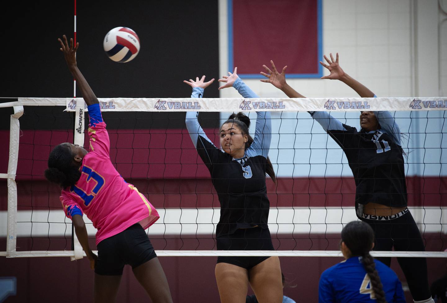 Kankakee's Karmen Rodgers, center, and Shania Johnson, right, try to block a hit from Bloom's Lexi Frey on Tuesday, October 14, 2025.