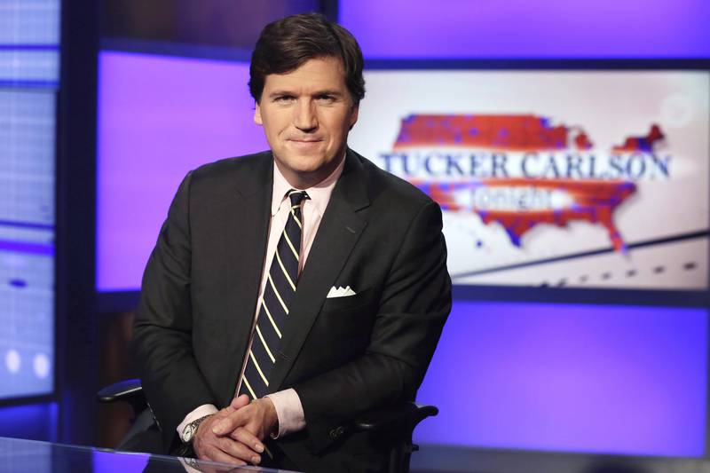 FILE - Tucker Carlson, host of "Tucker Carlson Tonight," poses for photos in a Fox News Channel studio on March 2, 2017, in New York. (AP Photo/Richard Drew, File)