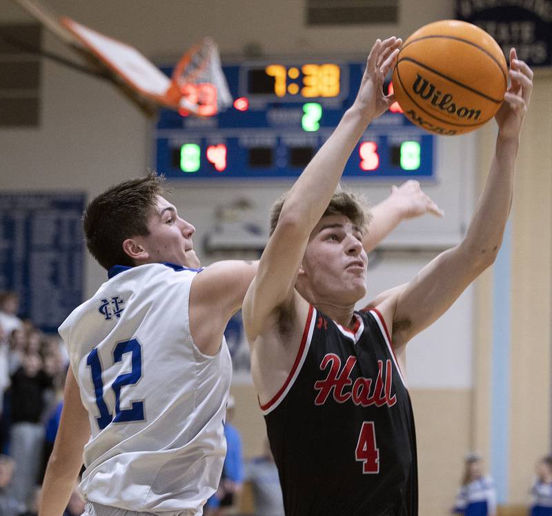 Hall’s Luke Bryant grabs a rebound in front of Newman’s Evan Bushman Friday, Jan. 17, 2025 at Newman High School.
