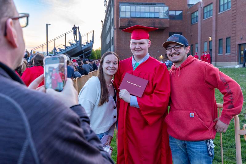 Brad Haage takes photo of (left to right) Emma Haage, Owen Haage and Riley Haage on Friday May 23, 2025 at Ottawa High School in Ottawa.