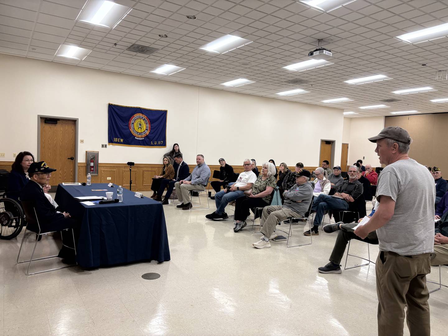 Dean Parr of Crystal Lake, right, asks U.S. Sen. Tammy Duckworth a question during a town hall May 17, 2025.