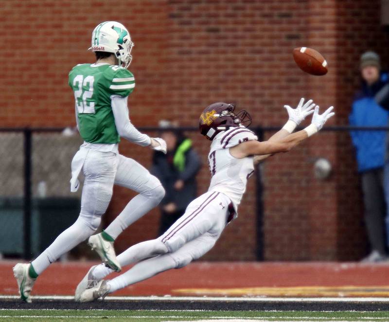 York’s Jack Korzeniowski (22) is called for pass interference as Loyola's Declan Forde (17) dives to attempt a touchdown reception during the IHSA Class 8A semifinal football game Saturday November 19, 2022 in Elmhurst.