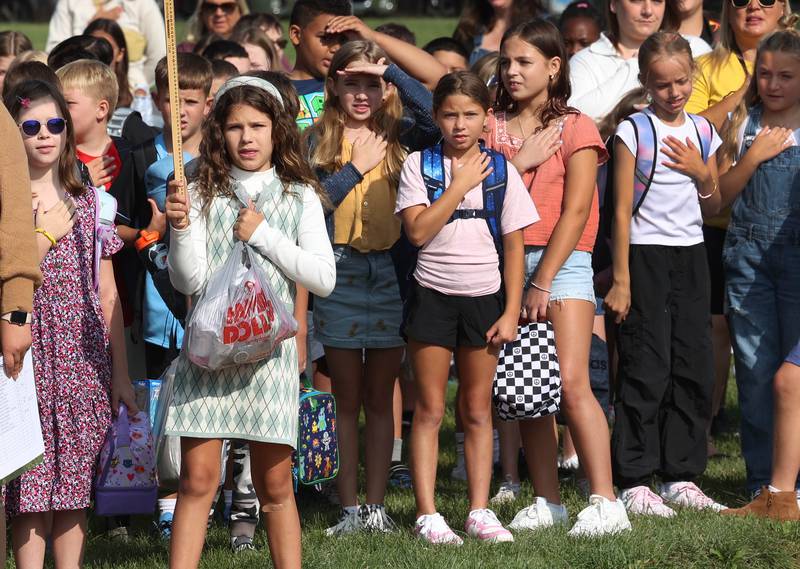 Southeast Elementary School students say the Pledge of Allegiance as they arrive for the first day of classes Thursday, Aug. 21, 2024, at the school in Sycamore.