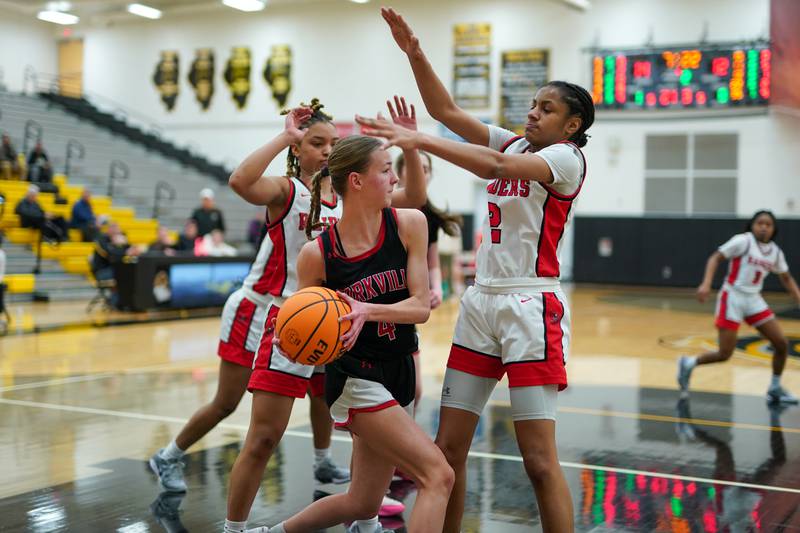 Bolingbrook's Amya Simmons (left), and Kennedy Williams (right), press Yorkville's Macie Jones (4) under the basket during a Class 4A Metea Valley Regional final basketball game at Metea Valley High School in Aurora on Friday, Feb. 21, 2025.