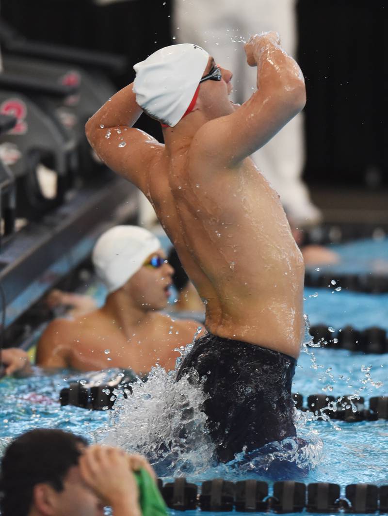 Hinsdale Central’s Joshua Bey celebrates his state-record breaking victory in the 100-yard breaststroke during the boys state swimming and diving finals at FMC Natatorium on Saturday, Feb. 24, 2024 in Westmont.