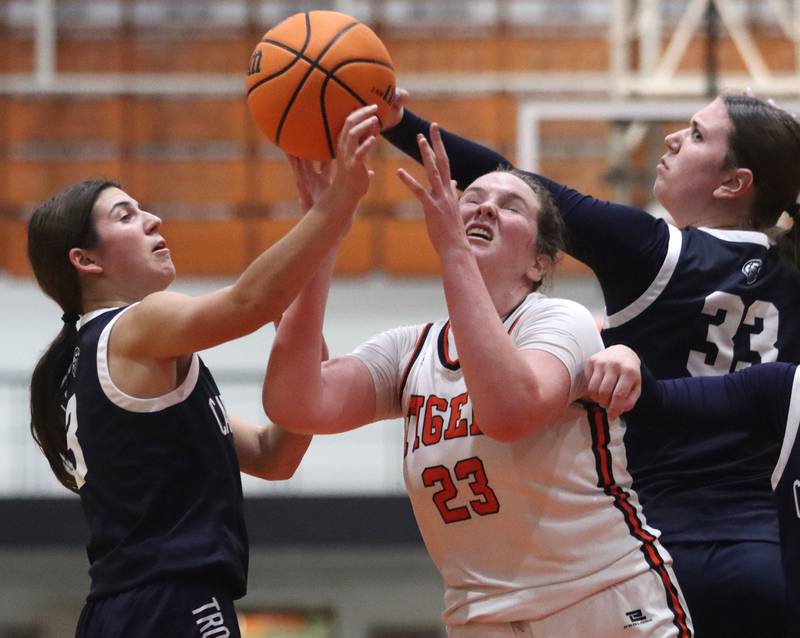 Cary-Grove’s Kennedy Manning, left, and Elizabeth Mjaanes, right, battle Crystal Lake Central’s Leah Spychala for the ball in varsity girls basketball on Tuesday, Jan. 7, 2025, at Crystal Lake Central High School in Crystal Lake.