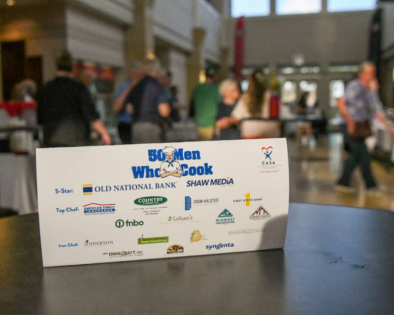Community members walk the hallway of Northern Illinois University Barsema Alumni and Visitors Center on Saturday, Aug. 9, 2025, as the doors open for CASA DeKalb County's annual 21st Men Who Cook fundraiser.