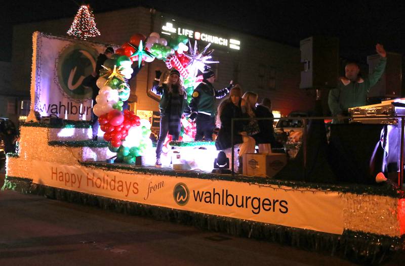 Jenny McCarthy and Donnie Wahlberg wave to the crowds during the Electric Christmas Parade, part of the City of St. Charles’ Holiday Homecoming festivities, on Main Street in St. Charles on Saturday, Nov. 26, 2022. The events were hosted by the St. Charles Business Alliance.