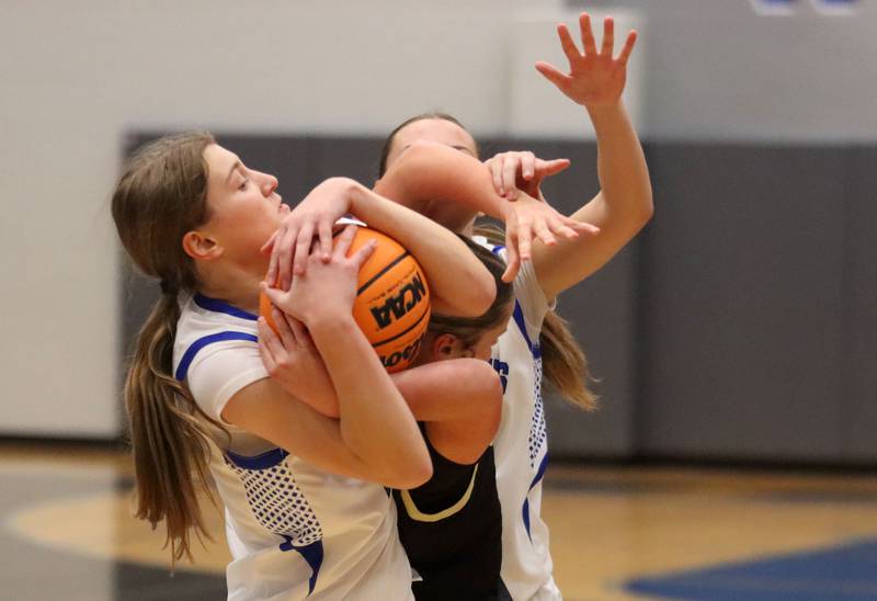 Burlington Central’s Scarlett Lafleur battles for the ball against Sycamore in girls basketball at Burlington Central High School in Burlington on Tuesday, November 18, 2025.
