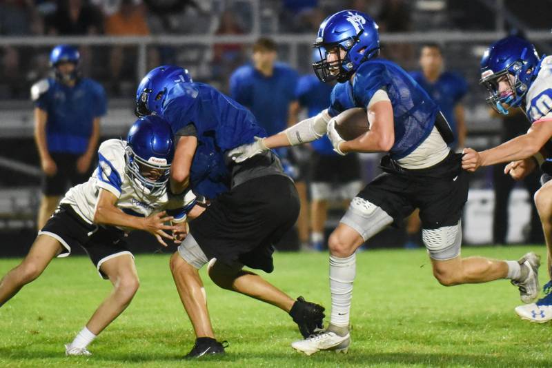 Peotone's Nick Cronin, third from left, runs the ball as a teammate helps him run between a pair of Clifton Central defenders during scrimmage action at Manteno Thursday, July 24, 2025.