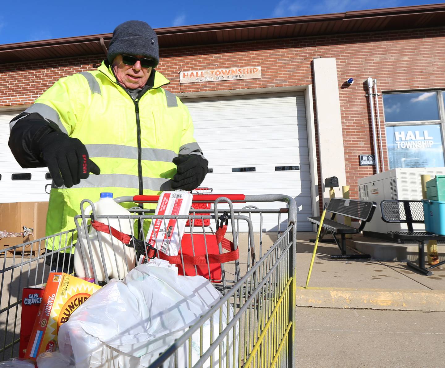 Volunteer Joe Nagle unloads a cart of food for a client on at the Hall Township Food Pantry on Wednesday, Nov. 30, 2022 in Spring Valley.