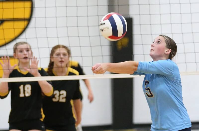 Marquette's Kealey Rick hits the ball to Putnam County's Salina Breckenridge and teammate Maggie Spratt on Thursday, Sept 7, 2023 at Putnam County High School.