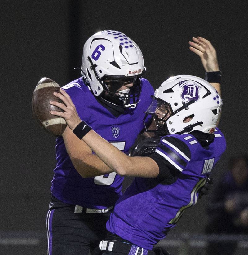 Dixon’s Logan Mershon (left) and Jagger Kemp celebrate an early touchdown against Woodstock North Friday, Oct. 31, 2025, in the Class 4A football first round playoffs.