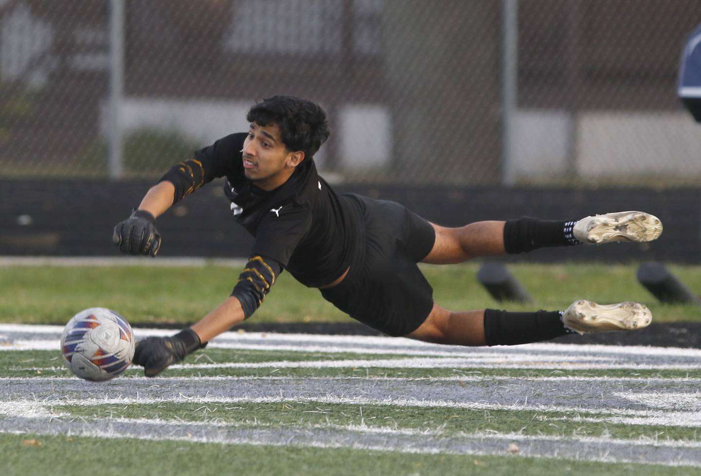 Harvard's Ricardo Flores makes a diving save during the IHSA Boys Soccer 2A Grayslake Central Sectional semifinal match against Wauconda on Tuesday, Oct. 29, 2024, at Grayslake Central High School,