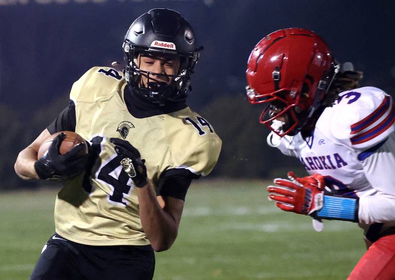 Sycamore's Josiah Mitchell gets ready to take the hit of Cahokia's Donald Collier during their game Friday, Oct. 25, 2024, at Sycamore High School.