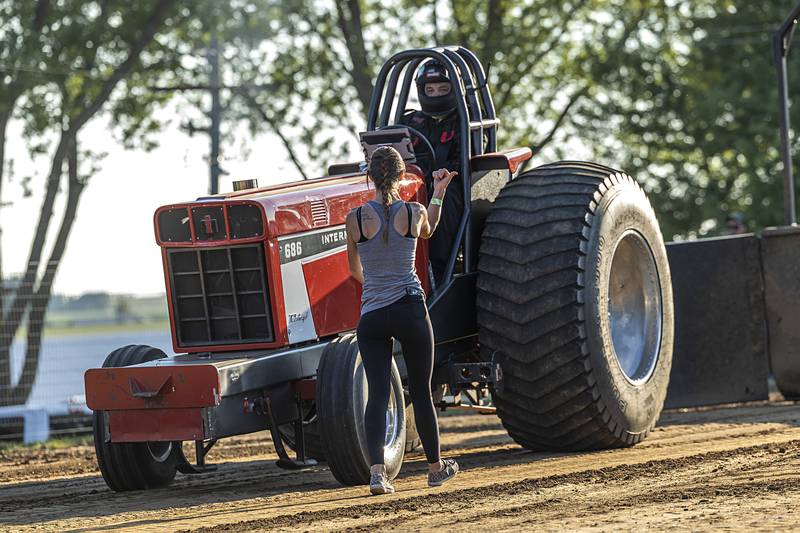 Driver Adam Nimtz is directed into position by a crew member Wednesday, Aug. 7, 2024, in Milledgeville.