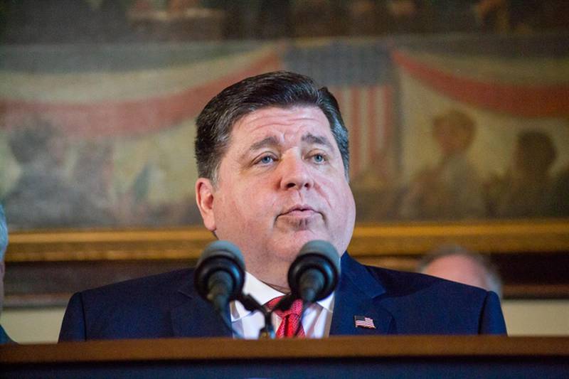 Gov. JB Pritzker is pictured in his Capitol office at a news conference earlier this month.