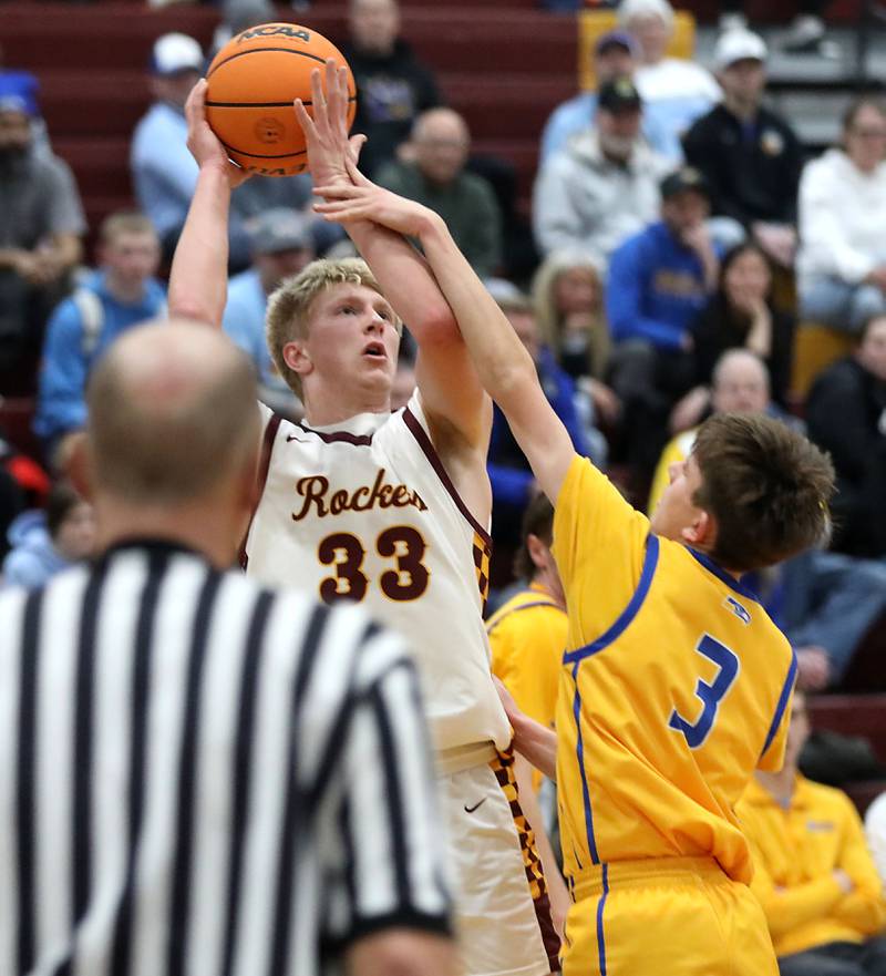 Richmond-Burton's Luke Robinson shots the ball over Johnsburg's Trey Toussaint during a Kishwaukee River Conference boys basketball game on Tuesday, Jan. 27, 2026, at Richmond-Burton High School.