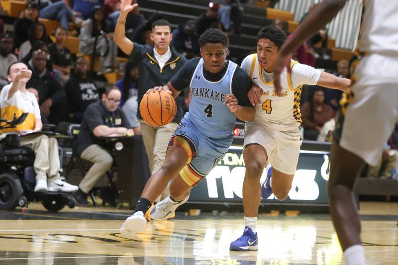 Kankakee’s Myair Thompson drives around Joliet West’s Brockton Goehrke on Wednesday, Feb. 18, 2026 in Joliet.