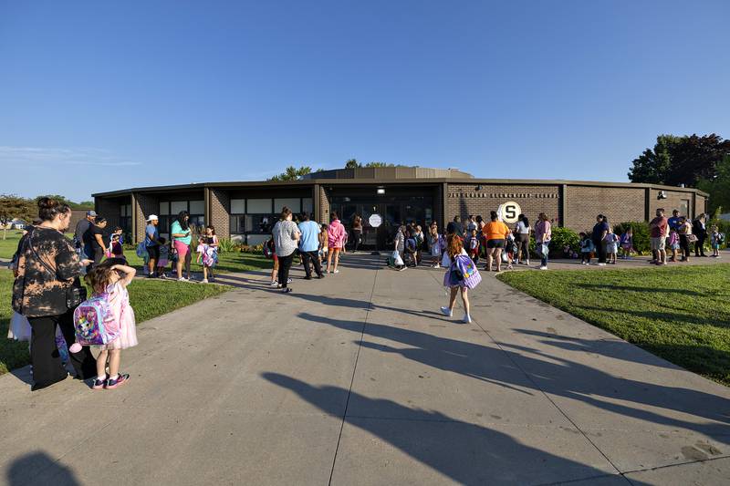 Parents and students gather outside of Jefferson School in Sterling Thursday, August 14, 2025, as the first day of class gets underway.