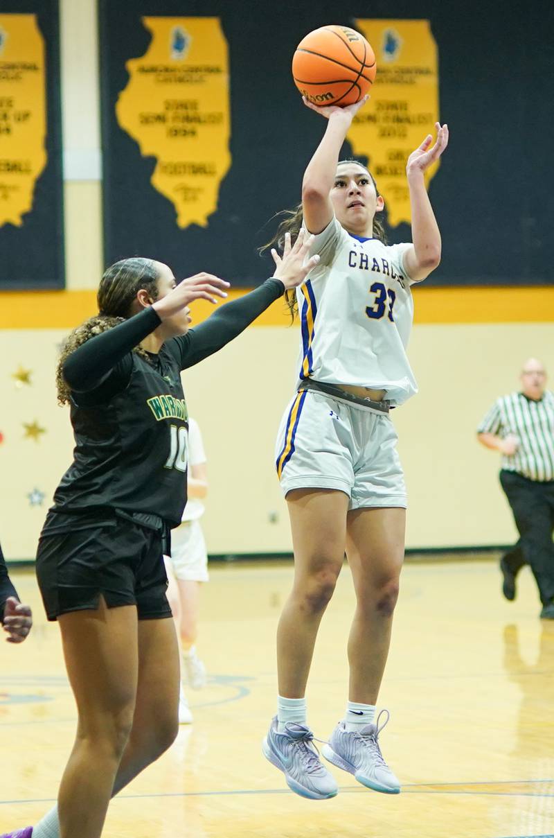 Aurora Central Catholic's Sofia Corral (33) shoots jumper against Waubonsie Valley's Danyella Mporokoso (10) during a basketball game at Aurora Central Catholic High School on Thursday, January 30, 2025.