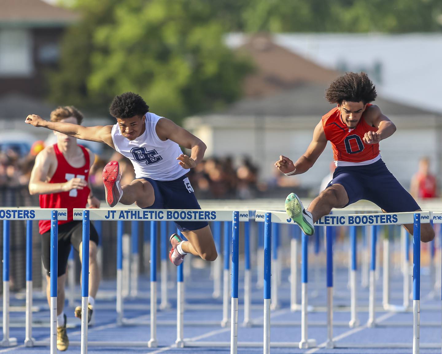 Oswego's Jezhian Sprinkle (R) edges out Oswego East's Donavin Eason in the 110mH during Southwest Prairie Conference Boys Track and Field Meet Wednesday, May 14, 2025 in Joliet.