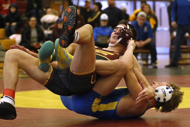 Richmond-Burton’s Dane Sorensen tries to get out of the grasp of Johnsburg’s Landon Johnson in their 132-pound third place wrestling match in the IHSA 1A Richmond-Burton Wrestling Regional Thursday, Jan. 19, 2023, at Richmond-Burton High School in Richmond.