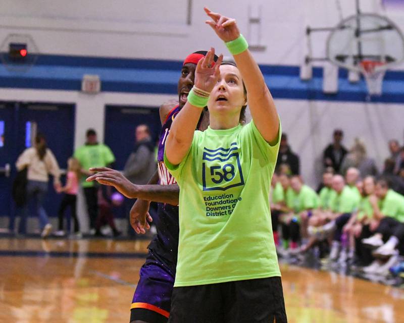 Christine Priester a Downers Grove staff member shoots the ball during the game on Sunday Jan. 19, 2025, while taking on the Harlem Wizard held at Downers Grove Souh High School.