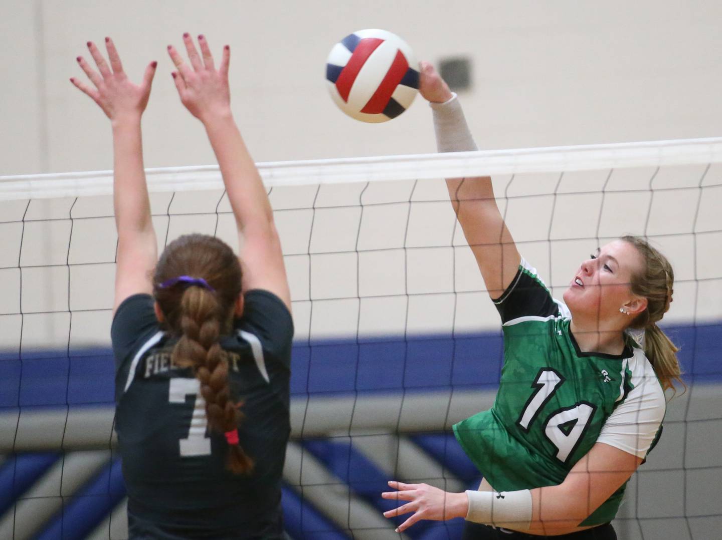 Rock Fall's Nicolette Udell sends a spike past Fieldcrest's Keara Barisch in the Class 2A Sectional semifinal game on Monday, Oct. 30, 2023 at Princeton High School.