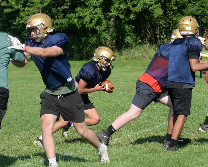Polo High School players work on an offensive play as head coach Ted Alston watches during practice on Wednesday, Aug. 13, 2025, in Polo.