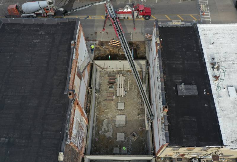 Crews pour the foundation of a new building at 205-207 W. Main St on Friday, Dec. 8, 2023 downtown Ottawa. The city had to close off Main Street in order to complete the pour.