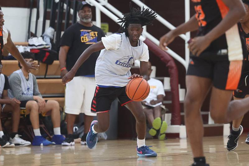 Joliet Central’s Deven Triplett takes the ball up-court against DeKalb at the 37th Morris Boys Shootout on Tuesday, June 25, 2024.