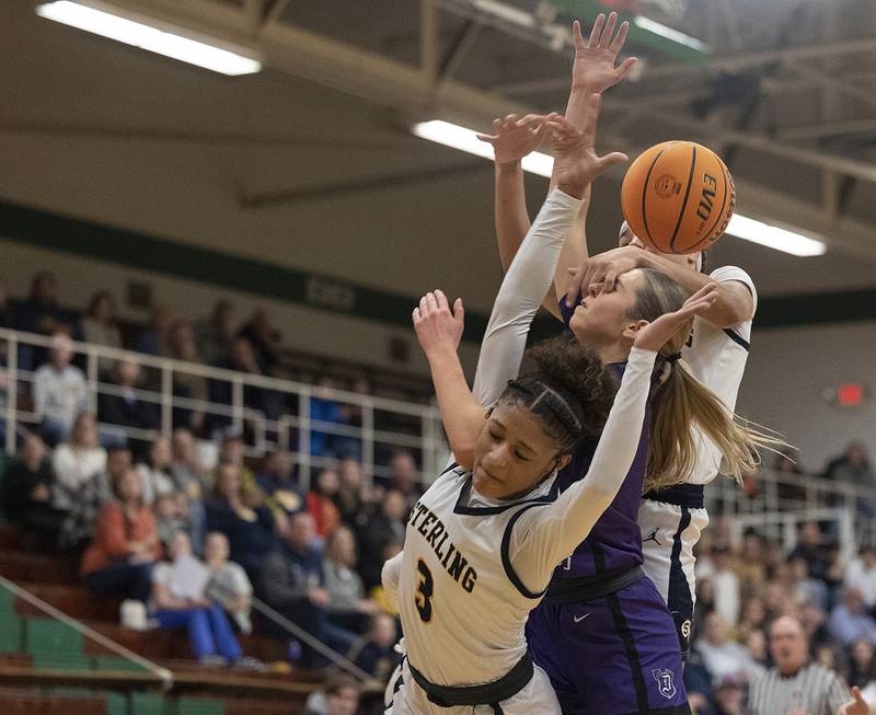Sterling’s Delali Amankwa, Dixon's Morgan Hargrove and Sterling’s Joslynn James get tangled up Thursday, Feb. 27, 2025, during the Class 3A girls Sectional title at Rockford Boylan High School.

This game might have been the most physical event I’ve covered. Local rivals going toe-to-toe for the sectional title, it was knock down, drag out.