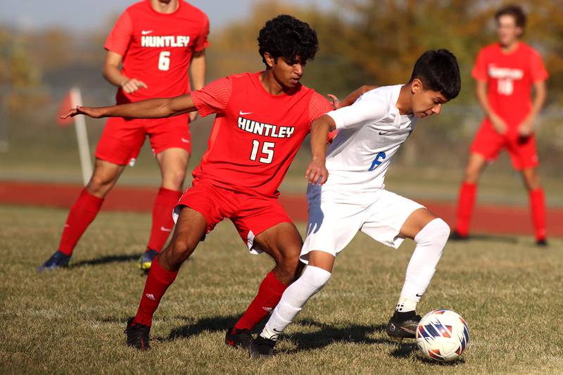 Huntley’s Ansel Dias, left, battles Larkin’s Reyli Perez in boys soccer regional action at South Elgin on Saturday.