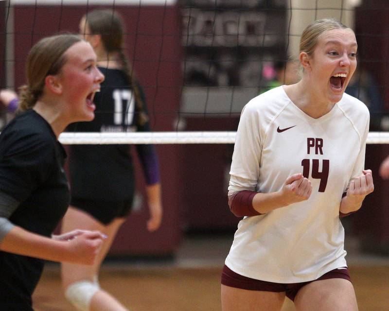 Prairie Ridge’s Jada Hoyt, right, and Allison Rogers get revved up against Hampshire during varsity volleyball on Thursday, Oct. 3, 2024, at Prairie Ridge High School in Crystal Lake.