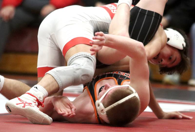 Huntley’s Cameron Abordo, top, battles Crystal Lake Central’s Peyton Ramsey at 120 pounds in varsity wrestling on Friday, Dec. 13, 2024 at Huntley High School in Huntley.