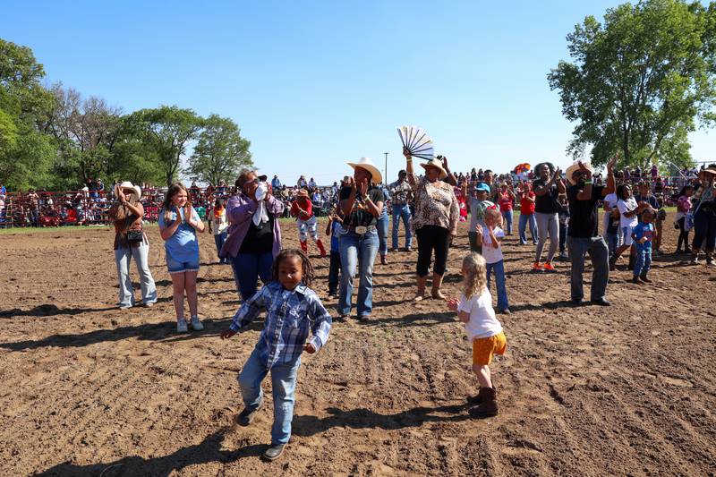 Attendees line dance during a break in competition at the 50th Pembroke Rodeo on Sunday, May 24, 2026.