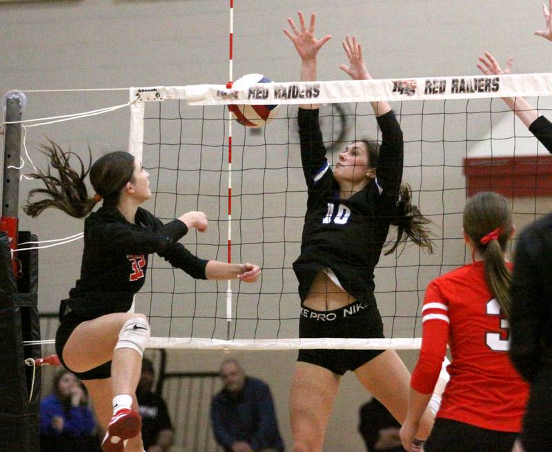 Huntley’s Elizabeth Whitehouse, left, and Burlington Central’s Julia Johnson battle at the net in varsity volleyball at Huntley High School in Huntley on Thursday, Oct. 24, 2024.