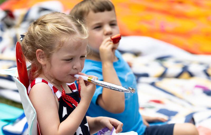 Matson Reilly, 4, blows a party noisemaker before the beginning of Glen Ellyn’s “4th of July Parade” on Friday, July 4, 2025.