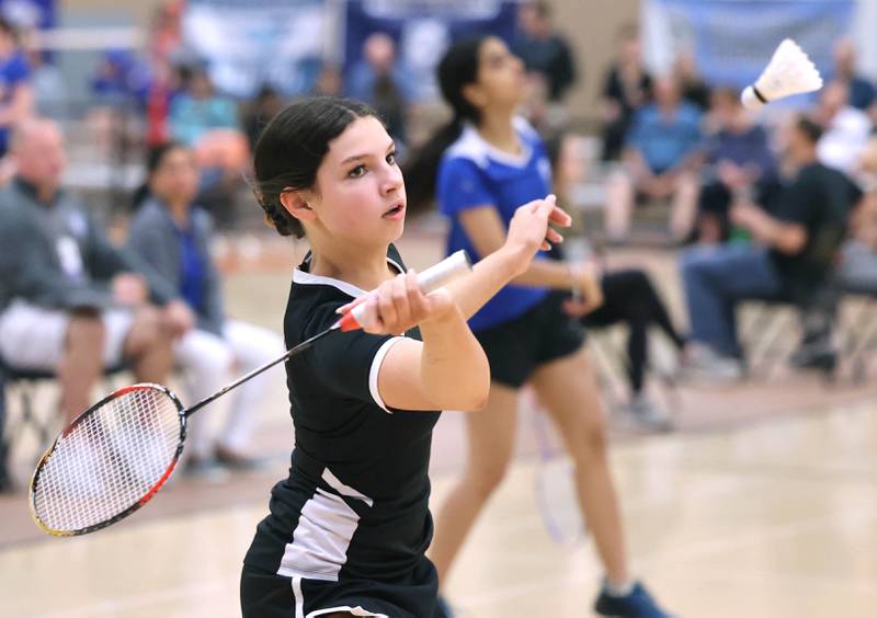 DeKalb’s Gwen Pfile hits a forehand Friday, May 12, 2023, during her match against  	Carissa Chen from the Illinois Math and Science Academy in the IHSA State Badminton Finals at DeKalb High School.