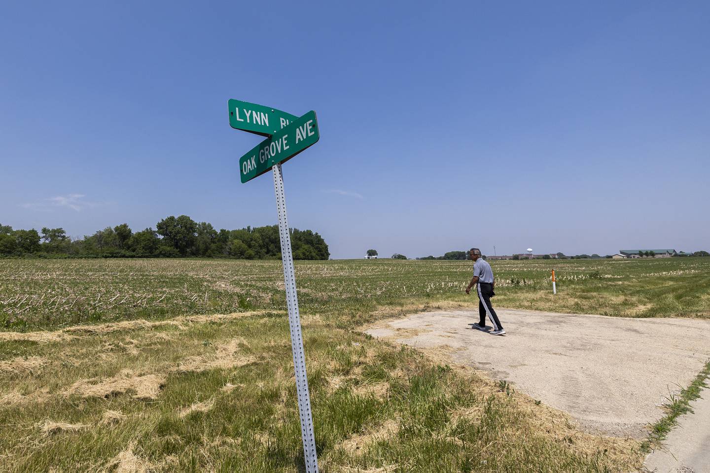 Larry Ybarra crosses Lynn boulevard Thursday, June 8, 2023 in Sterling to the site where he hopes to build a sports complex.