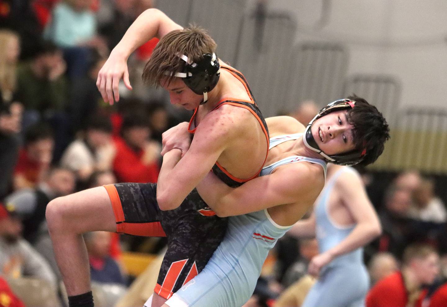 Marian’ Central's Diego Martinez throws Washington’s Sage Davis at 113 pounds in varsity boys wrestling on Thursday, Feb. 5, 2026, at Sycamore High School in Sycamore.