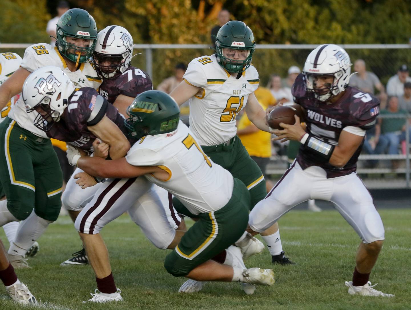 Prairie Ridge's Jack Finn is tackled by Crystal Lake South's Daniel Zebrowski as Prairie Ridge’s Joseph Vanderwell runs with he ball during a Fox Valley Conference Friday, Sept. 1, 2023, at Prairie Ridge High School inCrystal Lake.
