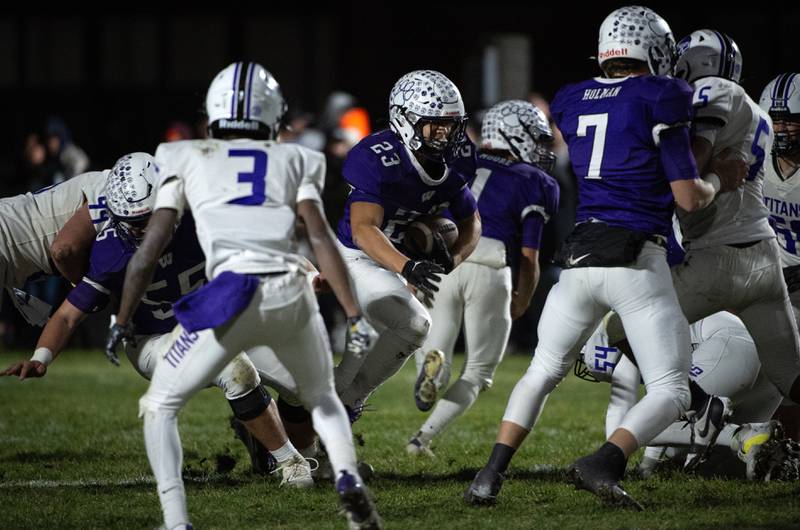 Wilmington's Hunter Kaitschuk, center, carries the ball on a play in the Class 2A semifinal against El Paso-Gridley on Saturday, November 22, 2025.